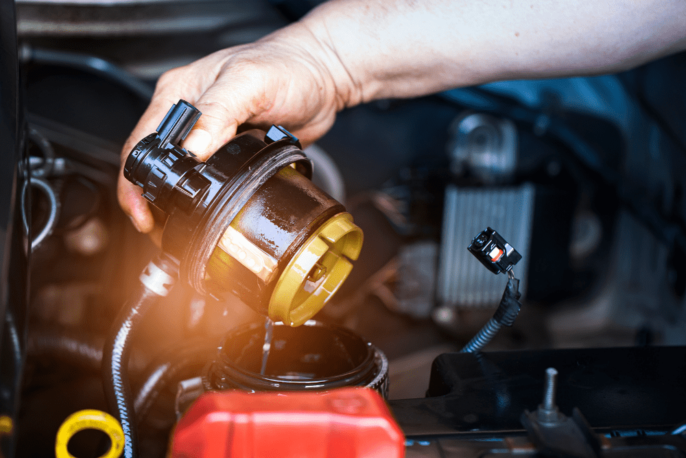 filter replacement, auto repair in York, PA at Quality Service Center. A mechanic replacing a car's fuel filter.