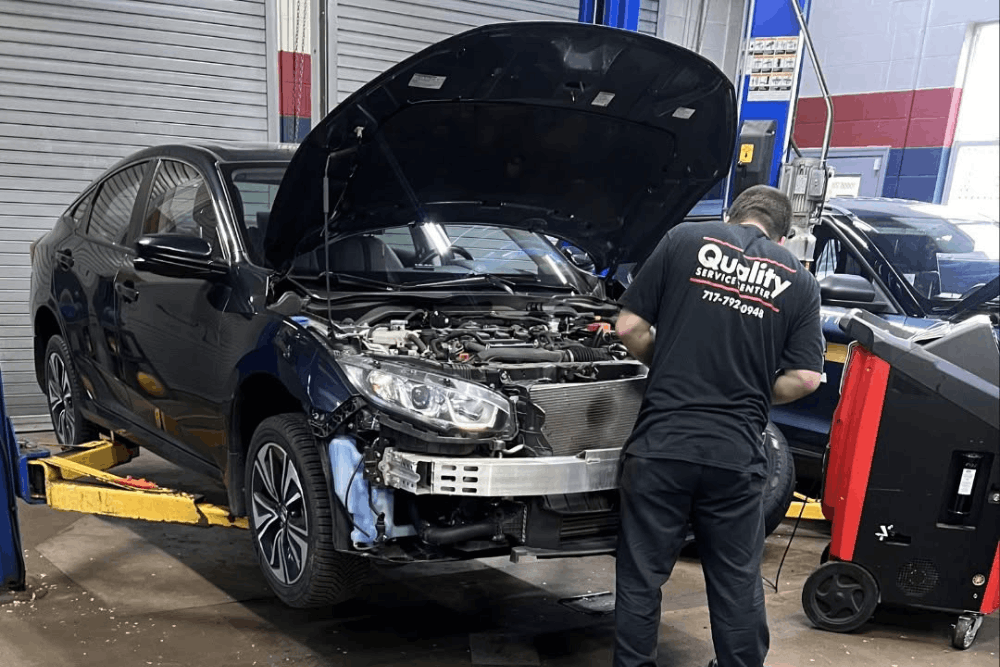 Japanese auto repair in York, PA, at Quality Service Center. Image of a technician servicing a Japanese sedan with the hood open, highlighting expert diagnostics and precision repairs that restore performance, reliability, and driver safety.